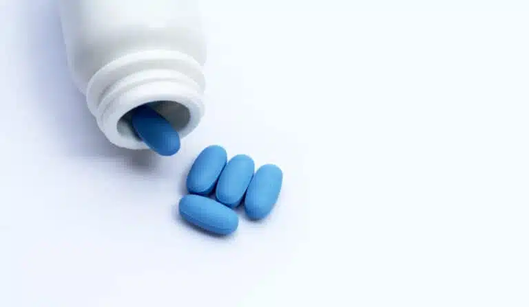 Blue tablet, PrEP medication in a bottle