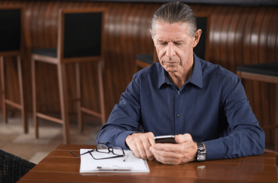 Older man reviewing health information considering testosterone level testing and treatment options.