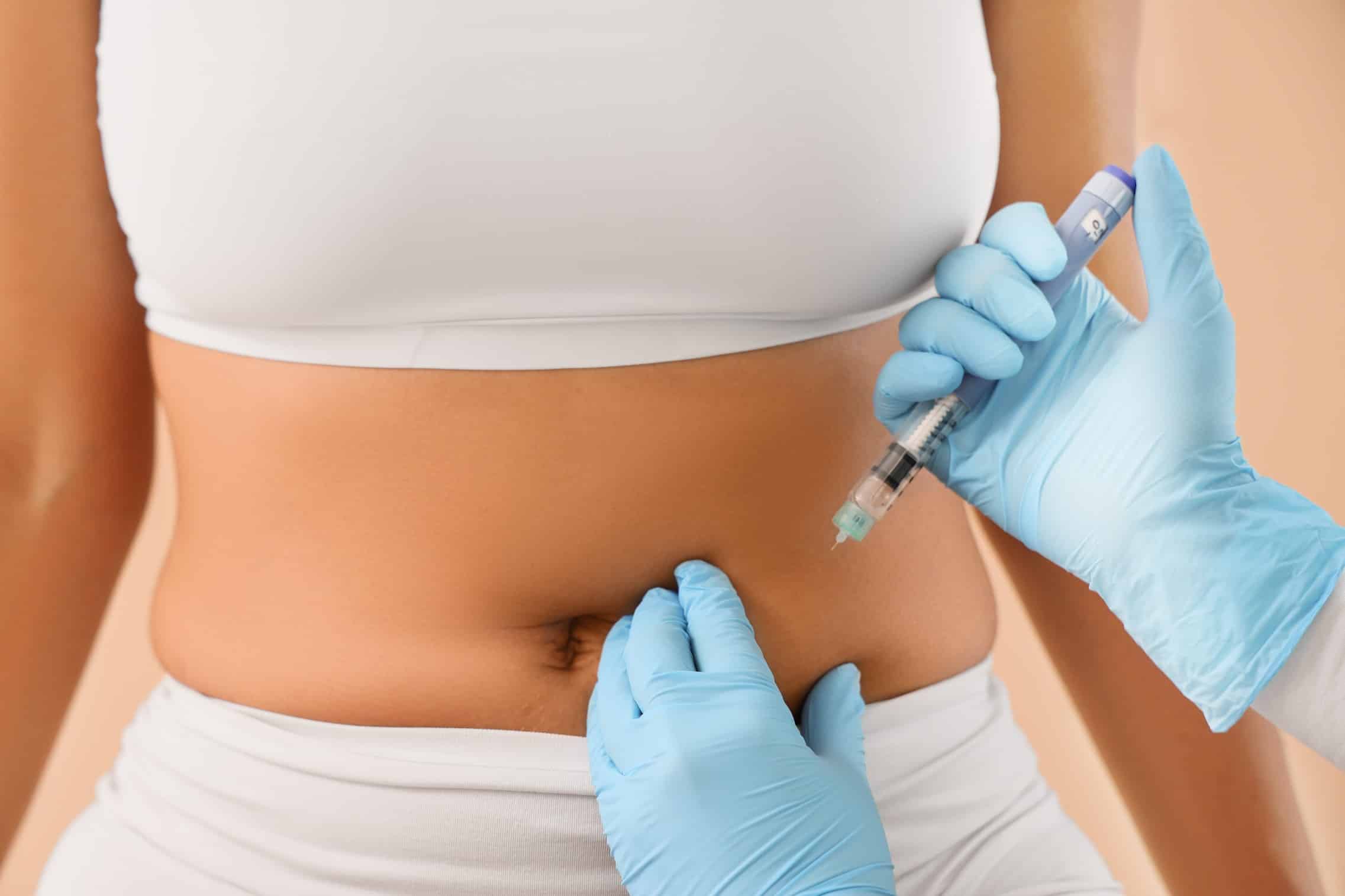 Medical professional injecting weight loss medication. But Wegovy vs Mounjaro, which is better?