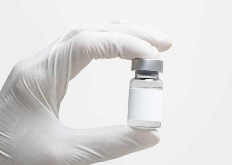Medical-grade retatrutide peptide vial held by physician at H.U.M. Clinic Bangkok
