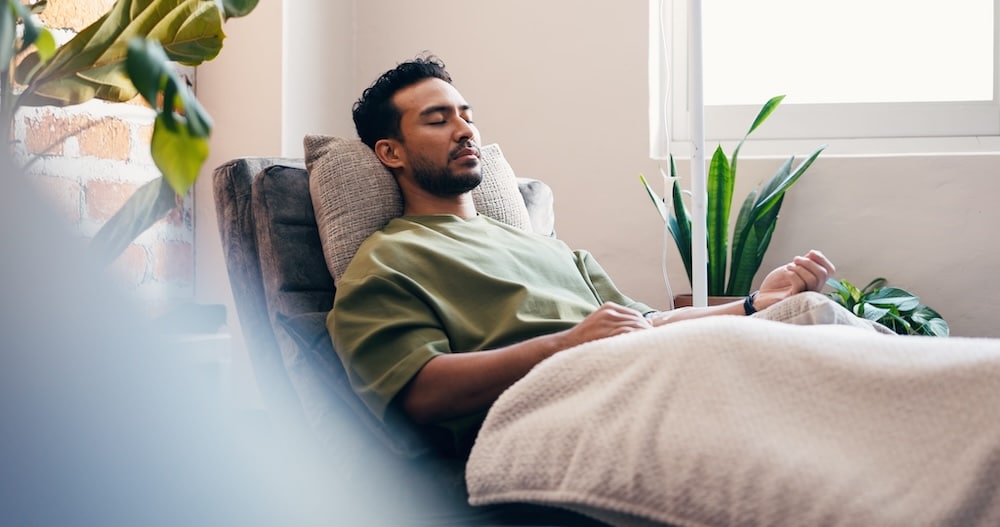 A man relaxing during an NAD+ IV therapy session at H.U.M. Clinic