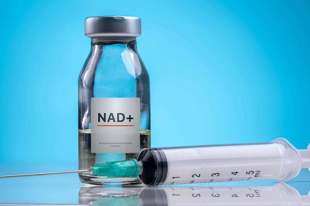 A vial of NAD+ and a syringe