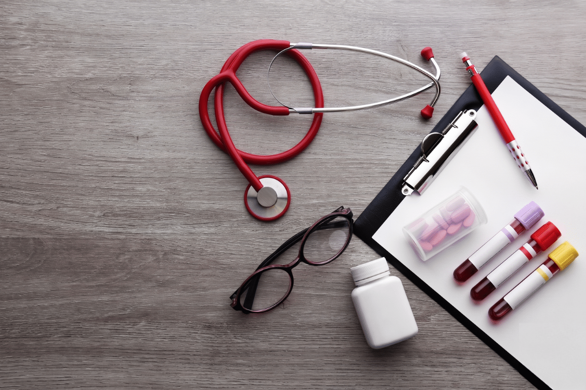 Blood test tubes, stethoscope and medical clipboard for comprehensive health screening