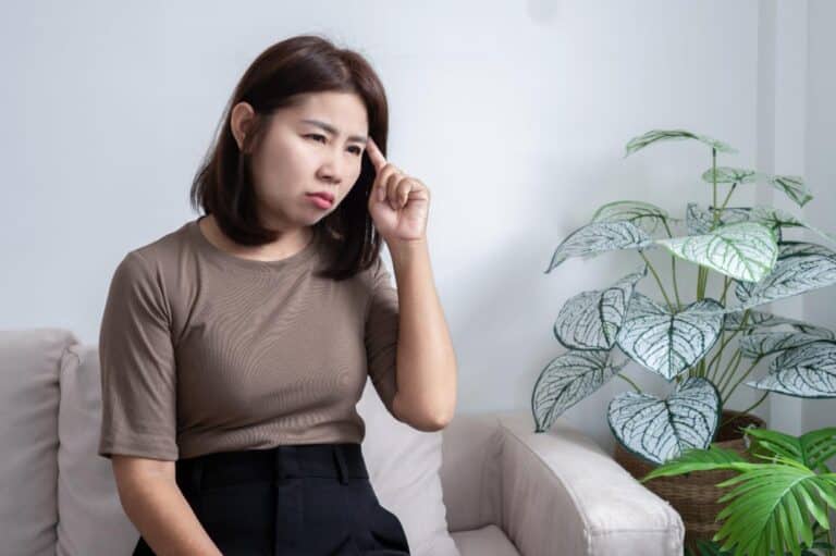 An Asian woman with impaired concentration, a main symptom of brain fog
