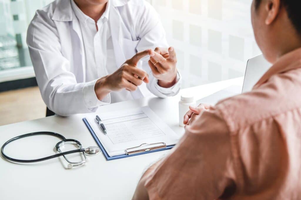 A doctor discusses stem cell therapy options with a patient in a clinical consultation setting
