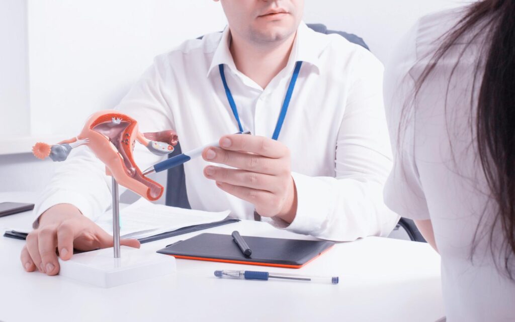A gynaecologist explaining to a female patient how untreated chlamydia can cause infertility.