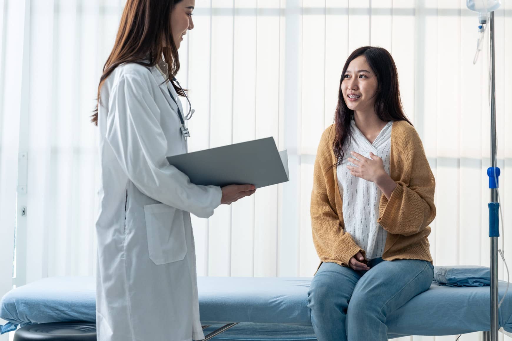 A young woman consulting a doctor about bacterial vaginosis symptoms in a clinic