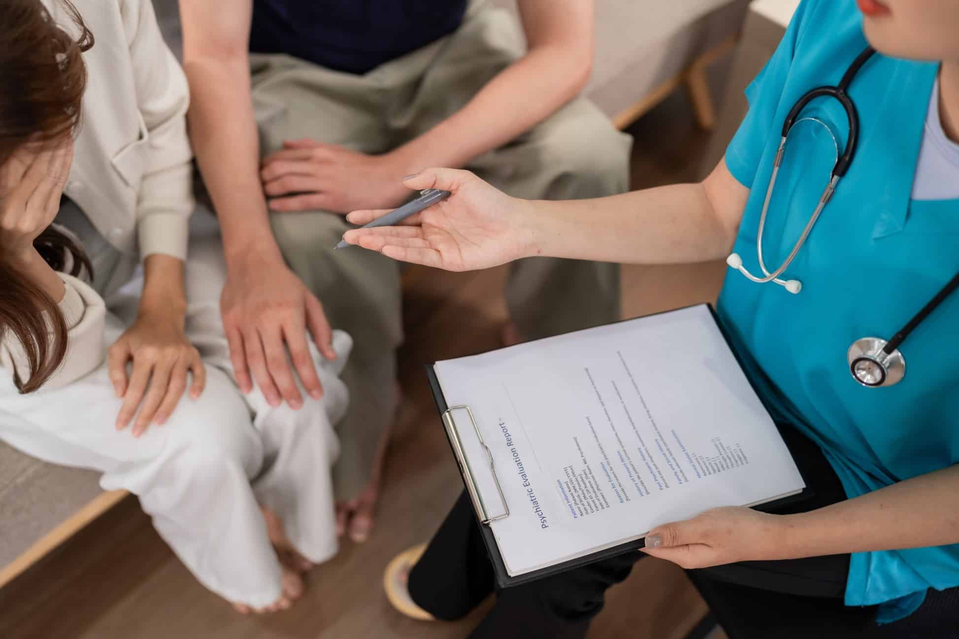 Doctor discussing oxytocin hormone health with a couple during a consultation