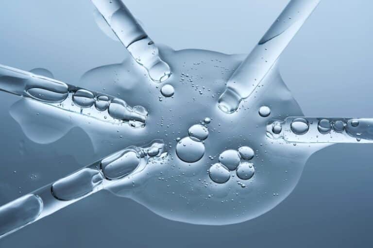 Droppers containing MOTS-c peptide compound on a table in a clinical setting.