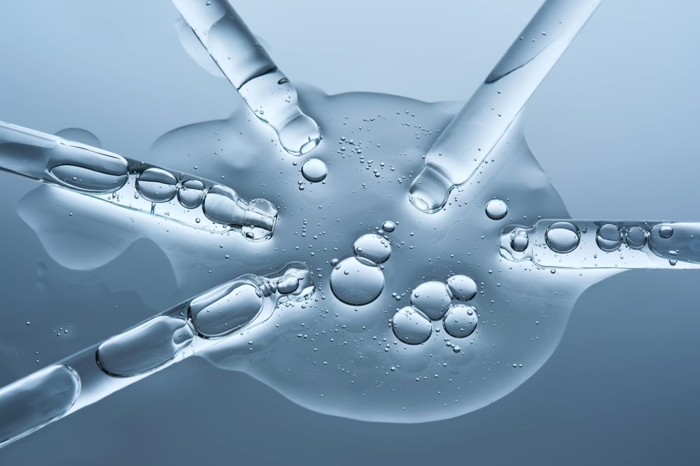 Droppers containing MOTS-c peptide compound on a table in a clinical setting.