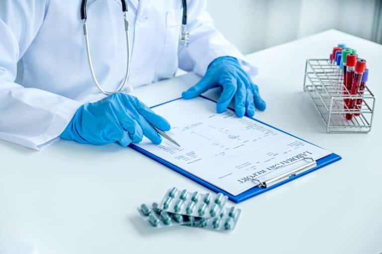Doctor reviewing blood test results and medication for high prolactin treatment