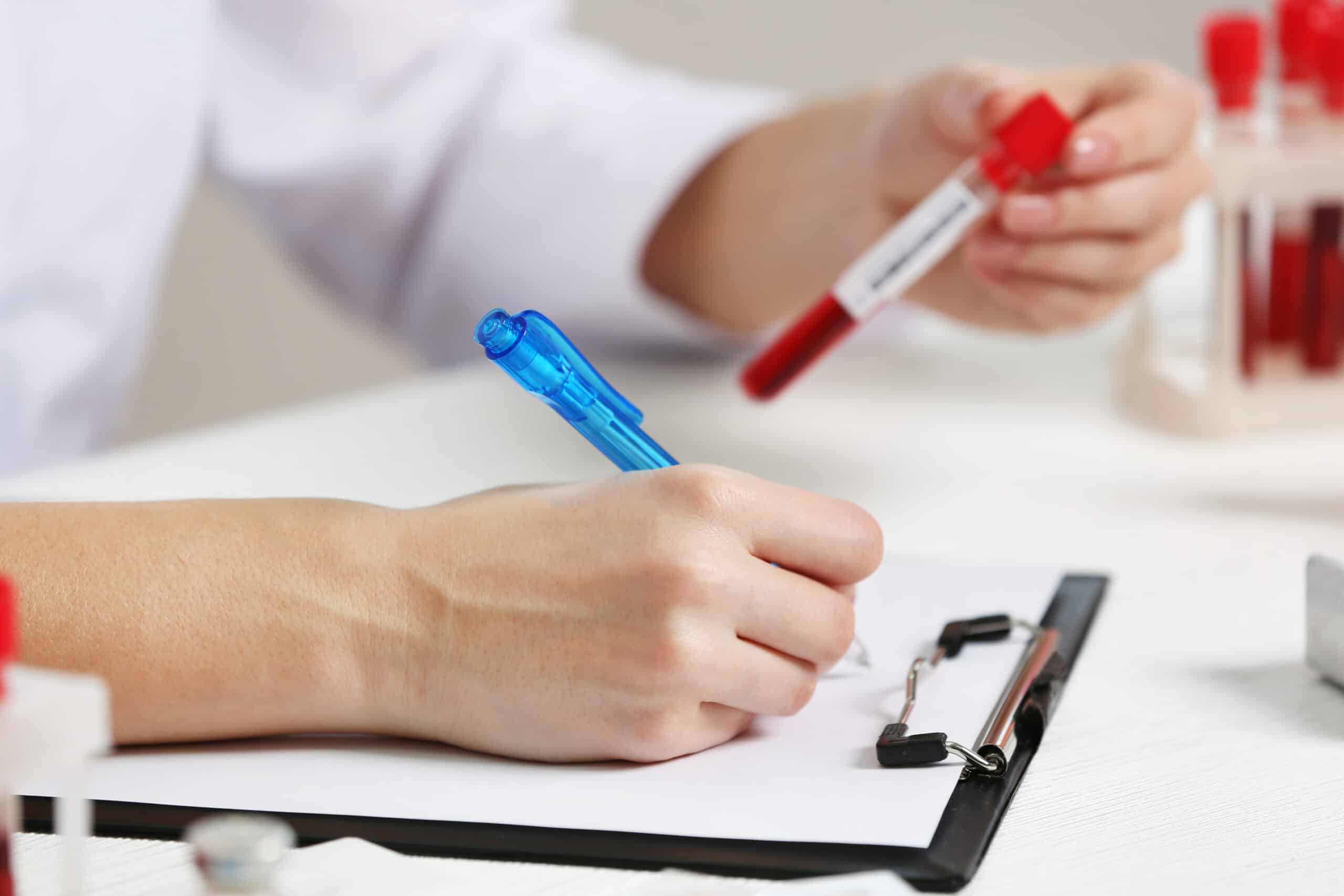 Describe a doctor reviewing hormone blood tests and possible diagnostic findings before deciding whether tamoxifen is appropriate for a male patient.