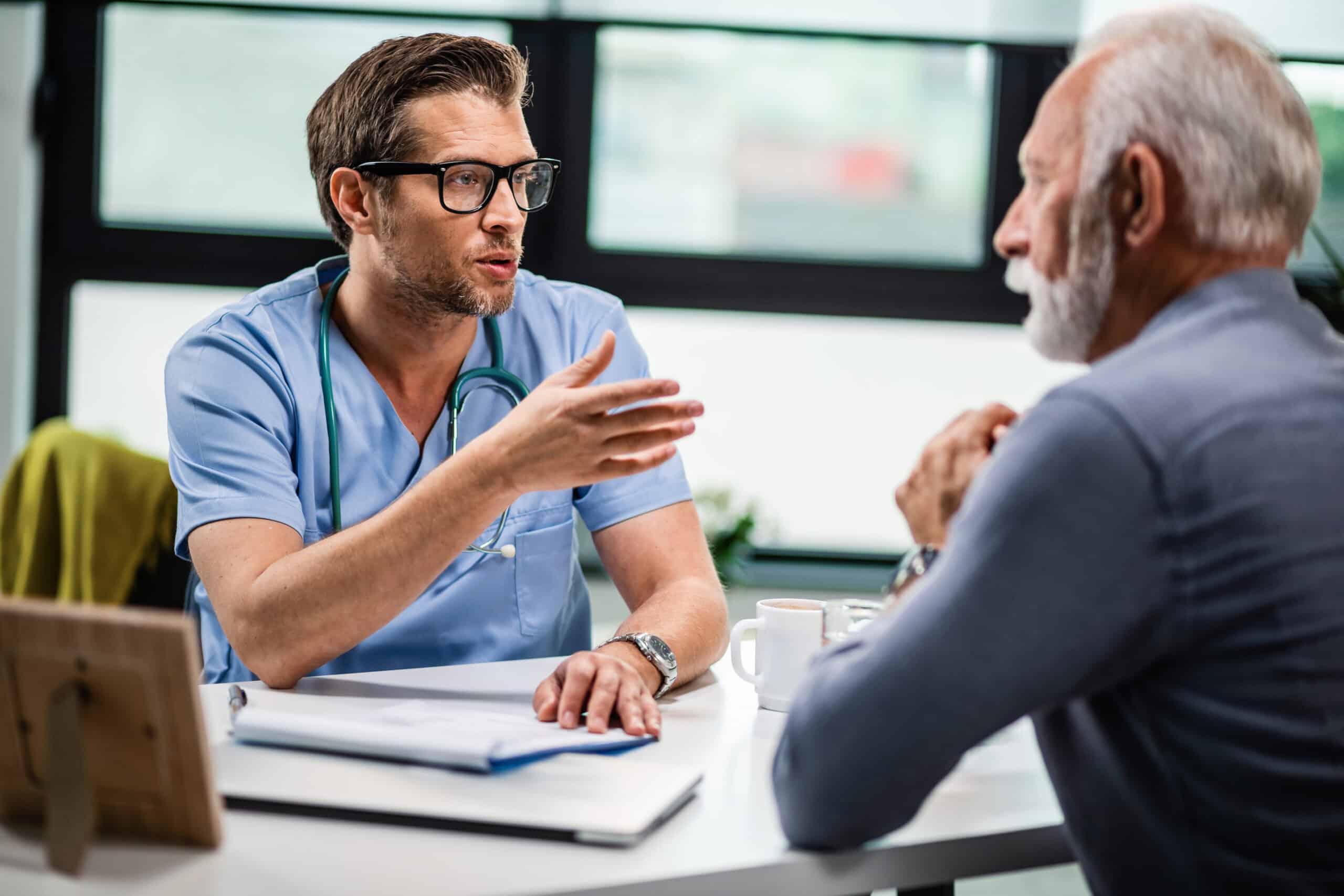 A doctor discusses tadalafil treatment with an older man during a medical consultation.